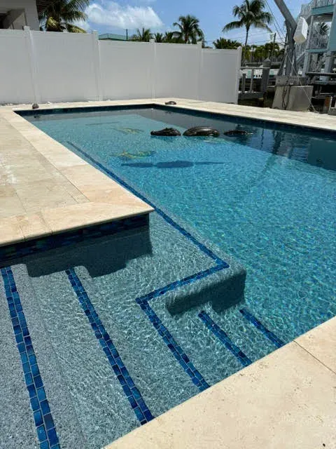 Pool entry steps with blue tile border accents